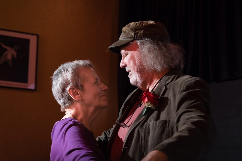 Larry Carius and his wife Kay dancing, looking at each other.