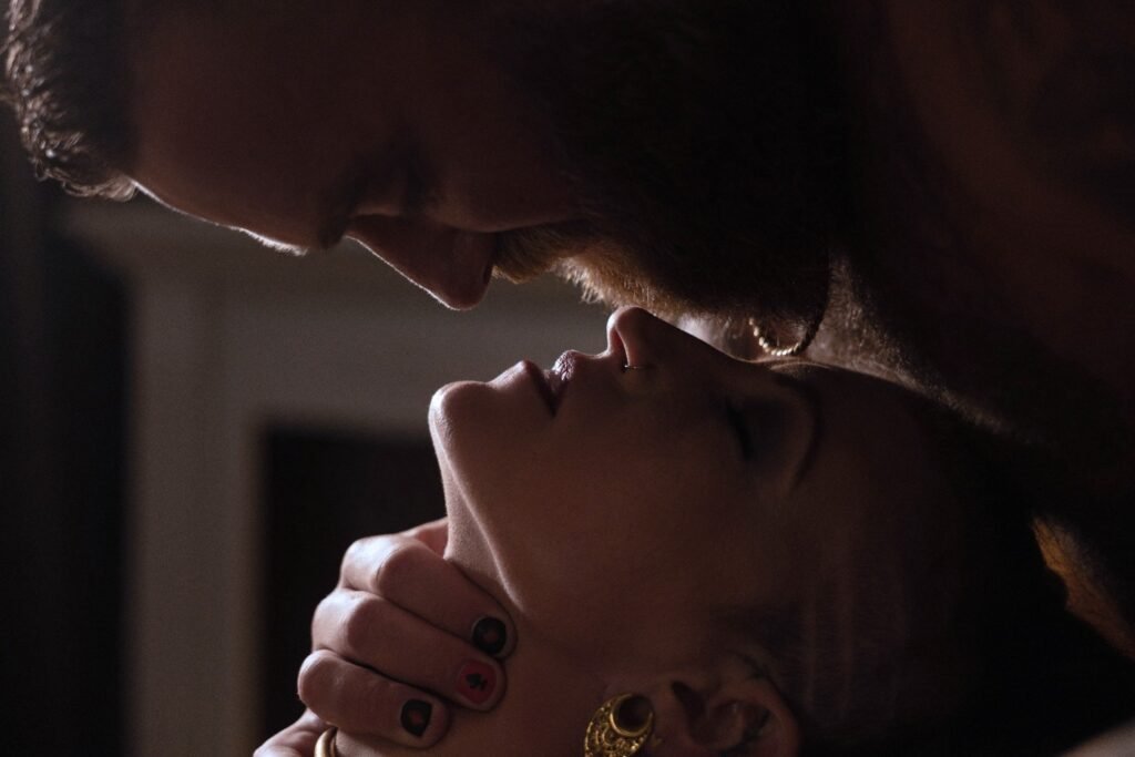 Romantic close-up of a couple during a softly lit boudoir photography session.